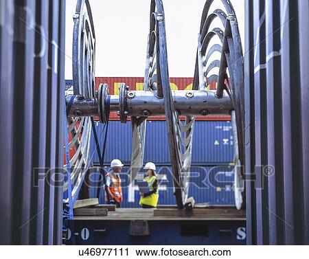 "Female and male workers inspecting shipping containers in port, Grimsby, England, United Kingdom" View Large Photo Image Stock Image - "Female and male workers inspecting shipping containers in port, Grimsby, England, United Kingdom". Fotosearch