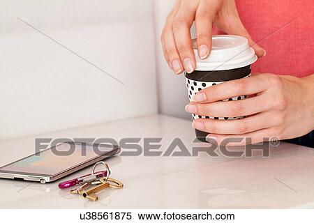 Female hands holding coffee next to smartphone View Large Photo Image Stock Photography - Female hands holding coffee next to smartphone. Fotosearch