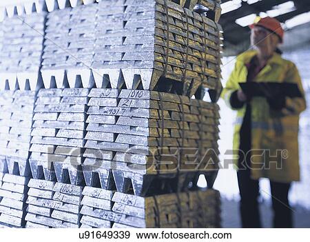 Female port worker with metal ingots in port View Large Photo Image Stock Photo - Female port worker with metal ingots in port. Fotosearch