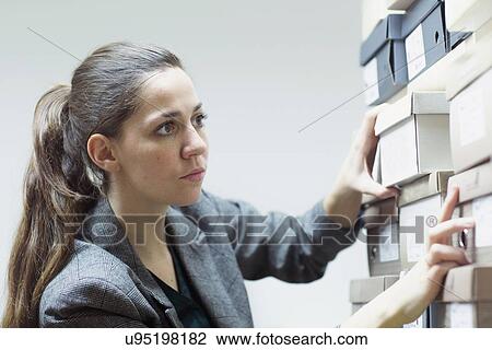 Female sales assistant searching for shoe box in shoe shop stockroom View Large Photo Image Stock Image - Female sales assistant searching for shoe box in shoe shop stockroom. Fotosearch