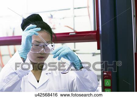 Female scientist pipetting sample in lab View Large Photo Image Stock Photograph - Female scientist pipetting sample in lab. Fotosearch