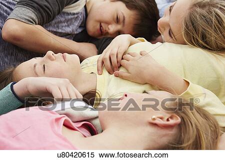 Five boys and girls lying down with eyes closed View Large Photo Image Stock Photography - Five boys and girls lying down with eyes closed. Fotosearch