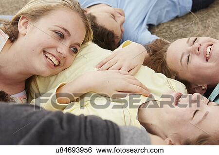 Five boys and girls lying on path laughing View Large Photo Image Stock Photograph - Five boys and girls lying on path laughing. Fotosearch