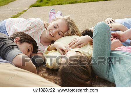 Five boys and girls lying together on path View Large Photo Image Stock Image - Five boys and girls lying together on path. Fotosearch