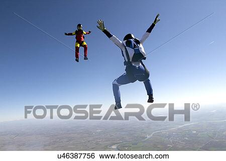 Freeflying skydivers in blue sky View Large Photo Image Stock Photograph - Freeflying skydivers in blue sky. Fotosearch