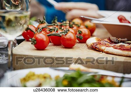 "Fresh vine tomatoes on chopping board, close up" View Large Photo Image Stock Photo - "Fresh vine tomatoes on chopping board, close up". Fotosearch