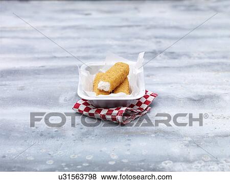 Fried chunky cod fish fingers in baking tin on steel table View Large Photo Image Stock Photo - Fried chunky cod fish fingers in baking tin on steel table. Fotosearch
