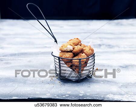 Frying basket full of breaded Scottish wholetail scampi View Large Photo Image Stock Image - Frying basket full of breaded Scottish wholetail scampi. Fotosearch
