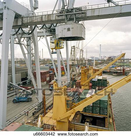 Stock Image - Gantry crane and containers on ship in port. Fotosearch