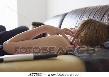 Girl and brother watching tv from sofa View Large Photo Image Picture - Girl and brother watching tv from sofa. Fotosearch