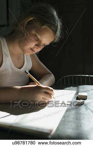 Girl doing her homework with pencil and notebook View Large Photo Image Stock Image - Girl doing her homework with pencil and notebook. Fotosearch