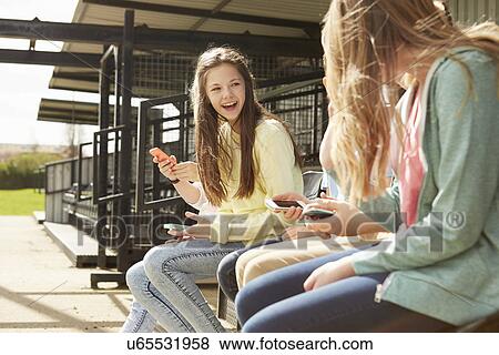 Girls and boys in stadium stand using smartphones View Large Photo Image Stock Photo - Girls and boys in stadium stand using smartphones. Fotosearch