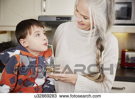 Grandmother offering grandson drink View Large Photo Image Stock Image - Grandmother offering grandson drink. Fotosearch