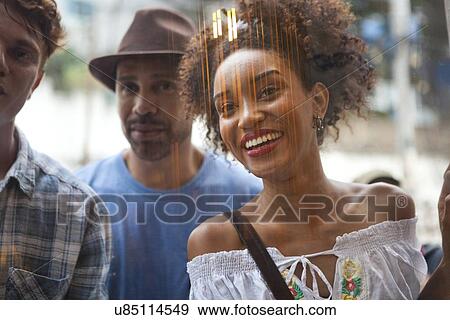 Stock Photo - Group of friends looking in shop window. Fotosearch