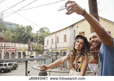 "Group of friends taking self portrait, using smartphone" View Large Photo Image Stock Image - "Group of friends taking self portrait, using smartphone". Fotosearch