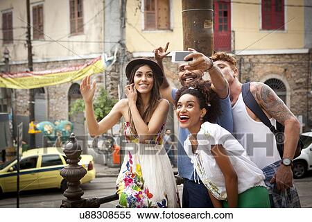 "Group of friends taking self portrait, using smartphone" View Large Photo Image Stock Photography - "Group of friends taking self portrait, using smartphone". Fotosearch