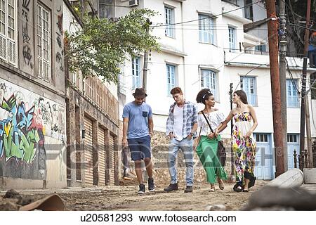 "Group of friends, walking along street together" View Large Photo Image Stock Image - "Group of friends, walking along street together". Fotosearch