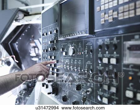 "Hand of engineer operating CNC lathe control panel, close up" View Large Photo Image Picture - "Hand of engineer operating CNC lathe control panel, close up". Fotosearch