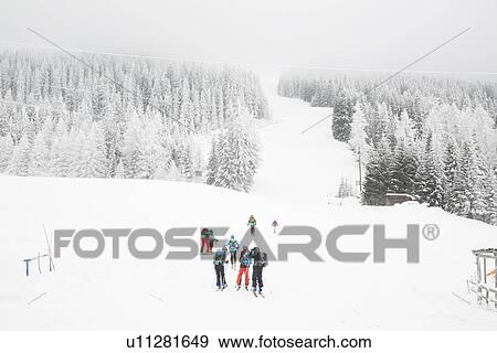 Stock Photo - "High angle view of skiers on ski slope, Tyrol, Austria". Fotosearch