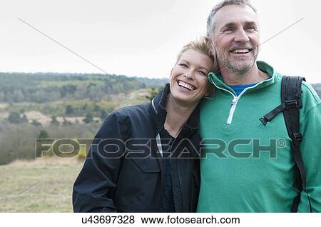 Hiking couple in rural landscape View Large Photo Image Stock Photo - Hiking couple in rural landscape. Fotosearch