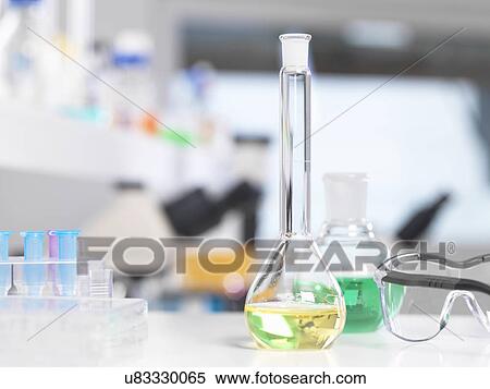Stock Photography - Laboratory glassware sitting on a lab bench during a experiment.. Fotosearch