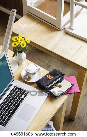 "Laptop and open purse on table, high angle view" View Large Photo Image Stock Photography - "Laptop and open purse on table, high angle view". Fotosearch