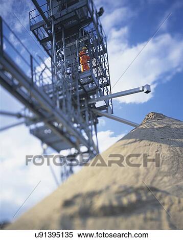 Stock Photography - Low angle view of sand storage in port. Fotosearch