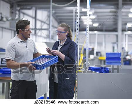 Male and female engineers discussing product View Large Photo Image Stock Photograph - Male and female engineers discussing product. Fotosearch