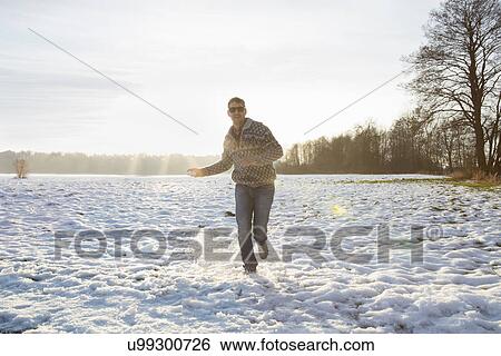 "Man enjoying nature in winter, Teising, Bayern, Deutschland" View Large Photo Image Stock Photograph - "Man enjoying nature in winter, Teising, Bayern, Deutschland". Fotosearch