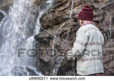 Man fishing by waterfall View Large Photo Image Stock Image - Man fishing by waterfall. Fotosearch
