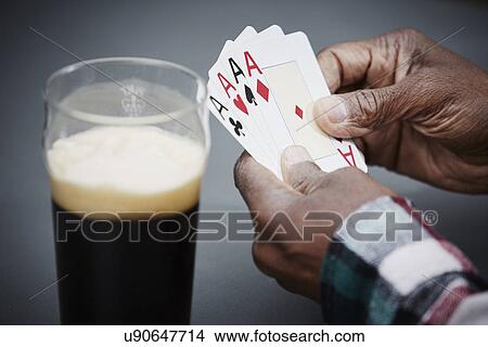 Man holding four ace cards with beer View Large Photo Image Picture - Man holding four ace cards with beer. Fotosearch