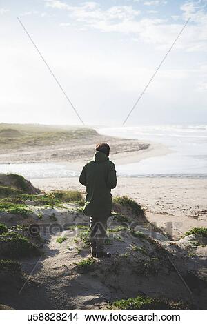 Picture - "Man looking out on coast from dunes, Sorso, Sassari, Sardinia, Italy". Fotosearch