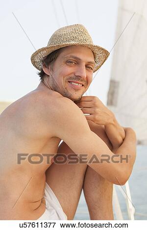 Stock Photo - Man on sailboat. Fotosearch