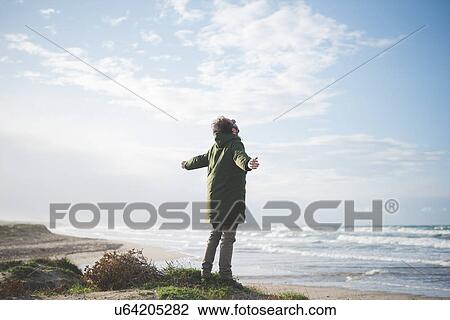 "Man on windy dunes with arms open, Sorso, Sassari, Sardinia, Italy" View Large Photo Image Stock Image - "Man on windy dunes with arms open, Sorso, Sassari, Sardinia, Italy". Fotosearch
