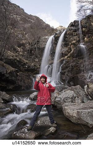 "Man photographing himself by waterfall, River Toce, Premosello, Verbania, Piedmonte, Italy" View Large Photo Image Stock Image - "Man photographing himself by waterfall, River Toce, Premosello, Verbania, Piedmonte, Italy". Fotosearch