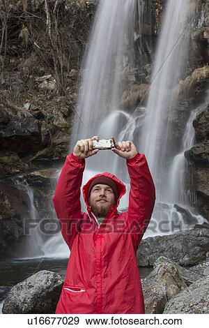 "Man photographing himself by waterfall, River Toce, Premosello, Verbania, Piedmonte, Italy" View Large Photo Image Stock Photo - "Man photographing himself by waterfall, River Toce, Premosello, Verbania, Piedmonte, Italy". Fotosearch