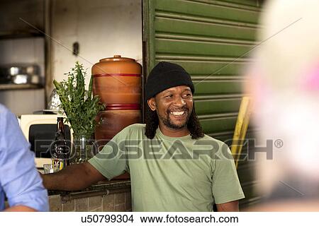 Picture - Man relaxing with beer in pub. Fotosearch