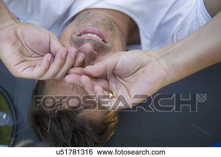 Stock Photograph - Man rubbing eyes. Fotosearch