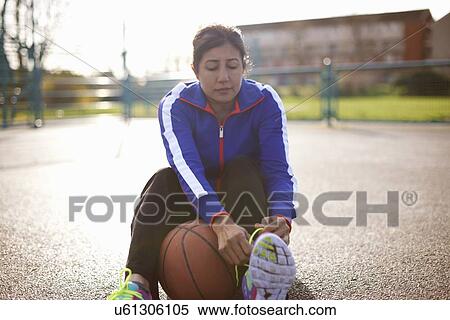 Mature female basketball player tying trainer laces View Large Photo Image Stock Photography - Mature female basketball player tying trainer laces. Fotosearch