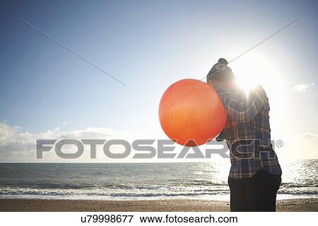 Mature man blowing up inflatable hopper at beach View Large Photo Image Stock Photo - Mature man blowing up inflatable hopper at beach. Fotosearch