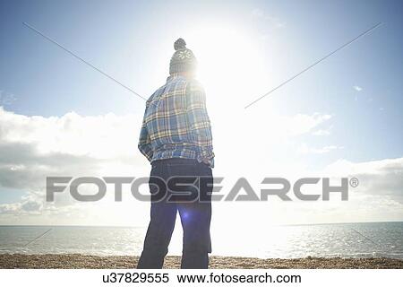 Mature man looking out to sea from beach View Large Photo Image Stock Photography - Mature man looking out to sea from beach. Fotosearch