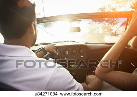 "Mid adult couple in convertible car, rear view, close-up" View Large Photo Image Picture - "Mid adult couple in convertible car, rear view, close-up". Fotosearch
