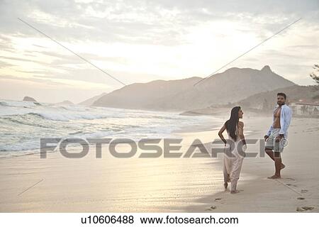 "Mid adult couple on beach, Rio de Janeiro, Brazil" View Large Photo Image Stock Photo - "Mid adult couple on beach, Rio de Janeiro, Brazil". Fotosearch