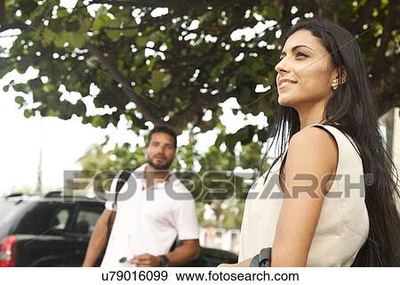 Stock Photo - "Mid adult couple, outdoors, focus on woman". Fotosearch