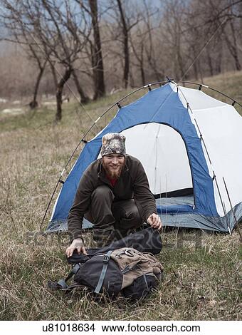Mid adult man by tent smiling towards camera View Large Photo Image Picture - Mid adult man by tent smiling towards camera. Fotosearch