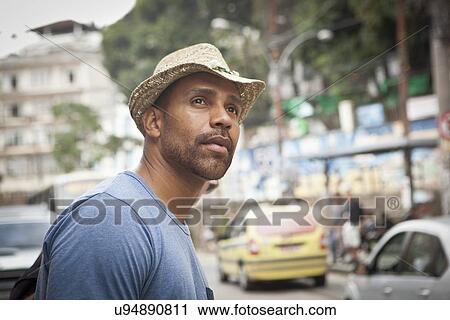 Stock Image - "Mid adult man crossing road, close-up". Fotosearch