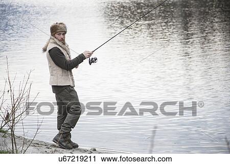 Mid adult man fishing View Large Photo Image Stock Image - Mid adult man fishing. Fotosearch