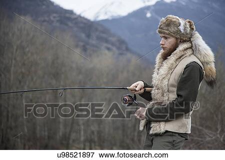 Mid adult man fishing View Large Photo Image Stock Photo - Mid adult man fishing. Fotosearch