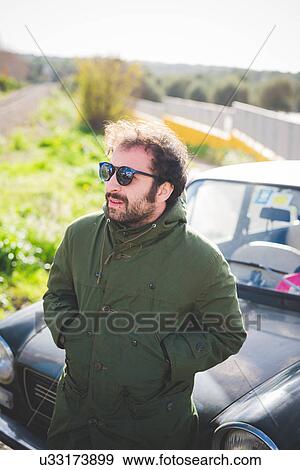 Mid adult man in front of vintage car View Large Photo Image Stock Photo - Mid adult man in front of vintage car. Fotosearch
