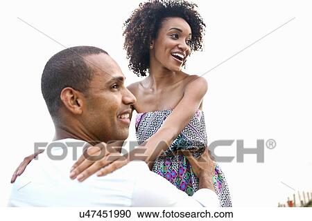 Mid adult man lifting up girlfriend at beach View Large Photo Image Stock Image - Mid adult man lifting up girlfriend at beach. Fotosearch